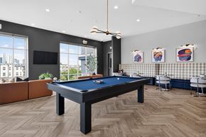 Charlotte apartment for rent - A pool table is in the middle of a room with a couch and a television.