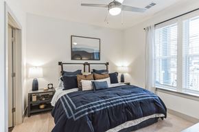 Waynesville apartment for rent - a bedroom with a bed and a ceiling fan