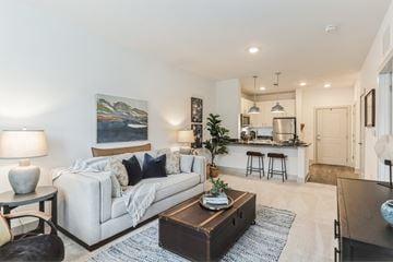 Waynesville apartment for rent - a living room with a couch and a coffee table in front of a kitchen
