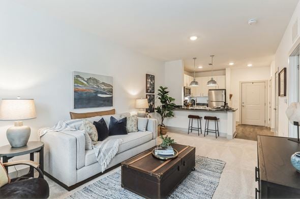 Waynesville apartment for rent - a living room with a couch and a coffee table in front of a kitchen