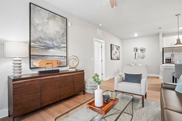 Oxford apartment for rent - A living room with a large painting on the wall and a wooden cabinet.