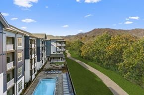 Waynesville apartment for rent - an aerial view of an apartment building with a pool and green lawn