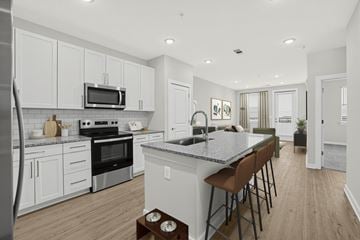 Duluth apartment for rent - A kitchen with white cabinets and a granite countertop.