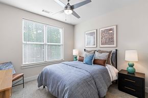 Raleigh apartment for rent - a bedroom with a bed and a ceiling fan