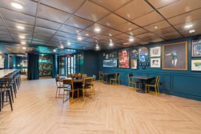 Raleigh apartment for rent - a dining room with blue walls and a wooden floor and tables and chairs
