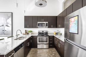 Winston-Salem apartment for rent - a modern kitchen with stainless steel appliances and granite counter tops