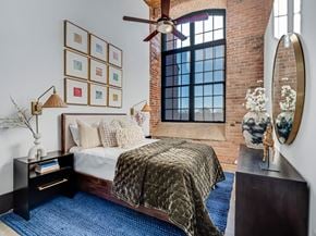 Gastonia apartment for rent - a bedroom with a bed and a ceiling fan