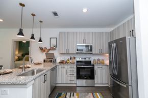 Lawrenceville apartment for rent - a kitchen with stainless steel appliances and granite counter tops