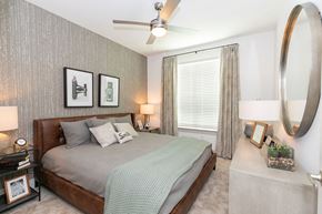 Lawrenceville apartment for rent - a bedroom with a bed and a ceiling fan