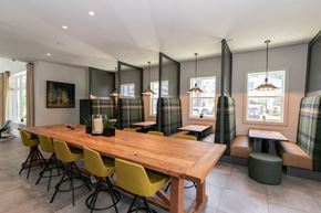 Lawrenceville apartment for rent - a dining room with a wooden table and yellow chairs