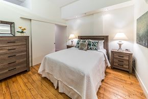 Winston-Salem apartment for rent - a bedroom with a bed and wooden floors