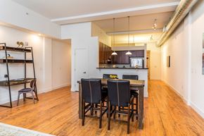 Winston-Salem apartment for rent - a dining room and kitchen with a wooden table and chairs