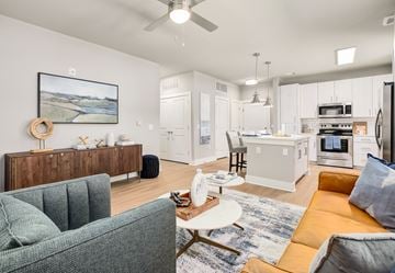 St Augustine apartment for rent - A living room with a green couch and a painting on the wall.