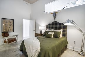 Winston-Salem apartment for rent - a bedroom with a bed and a skull on the wall