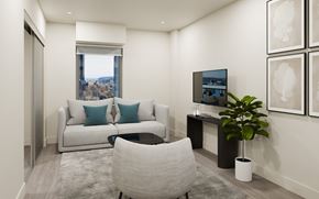 Halifax apartment for rent - A living room with a white couch, a grey chair, and a television.