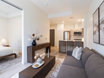 Halifax apartment for rent - A modern living room with a grey sofa and a wooden coffee table.