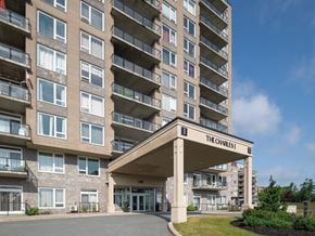 Halifax apartment for rent - The entrance to The Charles apartment building with a blue sky in the background.