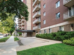 Halifax apartment for rent - A red brick apartment building with a green lawn in front.