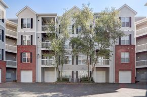 Herndon apartment for rent - an exterior view of an apartment building with trees in front of it