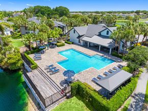 Boca Raton apartment for rent - A large house with a pool in the backyard.