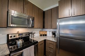 Denver apartment for rent - Apartments for Rent in Denver CO - Line 28 LoHi - Rooftop Lounge with City Views, Plant Boxes, Red Tile, Tables and Chairs, and Umbrellas