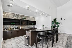 Franklin apartment for rent - A modern kitchen with dark wood cabinets and a bar area.