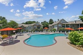 Franklin apartment for rent - A swimming pool surrounded by lounge chairs and umbrellas in a residential area.