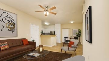 Chula Vista apartment for rent - A living room with a brown couch and a ceiling fan.