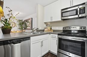 Pasadena apartment for rent - A modern kitchen with stainless steel appliances and white cabinets.