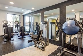 La Grange apartment for rent - A gym with a variety of equipment including treadmills, weights, and exercise machines.