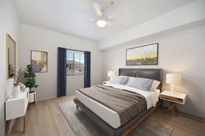Chula Vista apartment for rent - A bedroom with a large bed, a ceiling fan, and a painting on the wall.