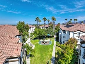 Chula Vista apartment for rent - The grounds at Teresina Apartments in Chula Vista, CA, featuring a playground a view of the apartment exteriors.