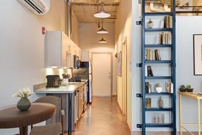Seattle apartment for rent - A kitchen with a table and a shelf with books and vases.