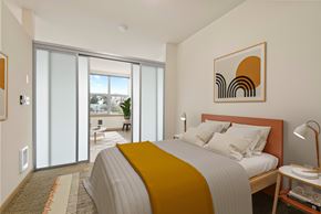 Seattle apartment for rent - A bedroom with a bed, nightstand, and a painting on the wall.