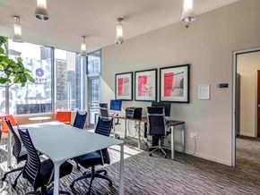 Seattle apartment for rent - A conference room with a table, chairs, and framed pictures on the wall.
