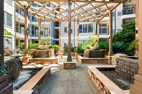 Atlanta apartment for rent - a courtyard with water fountain and seating in an apartment building
