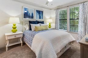 Atlanta apartment for rent - a bedroom with a bed and three windows