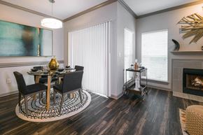 Austin apartment for rent - a dining room with a table and chairs next to a fireplace