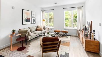 Framingham apartment for rent - A living room with a couch, chair, and a table with a plant on it.