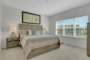 Exton apartment for rent - A bedroom with a large bed and a window overlooking a cityscape.
