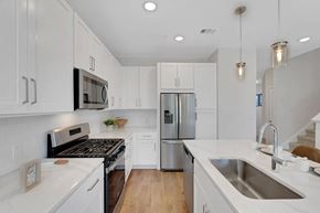 Exton apartment for rent - A modern kitchen with white cabinets and stainless steel appliances.
