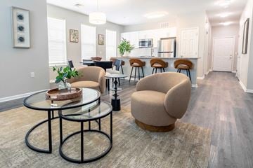 Lansdale apartment for rent - A modern living room with a glass table and two chairs.