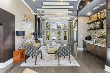 Germantown apartment for rent - A modern living room with a grey sofa and a patterned armchair.