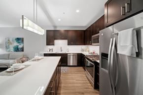 La Grange apartment for rent - A modern kitchen with dark wood cabinets and stainless steel appliances.