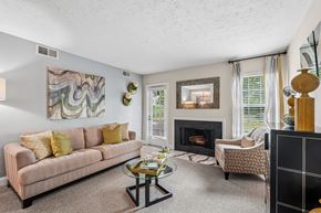 Germantown apartment for rent - A living room with a fireplace and a painting on the wall.