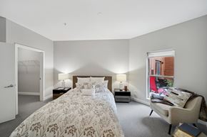 La Grange apartment for rent - A bedroom with a large bed and a chair.