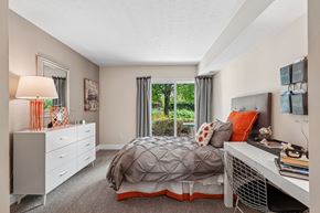 Germantown apartment for rent - A bedroom with a bed, nightstand, and window with curtains.