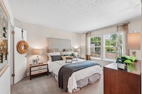 Germantown apartment for rent - A bedroom with two beds and a nightstand with a clock.