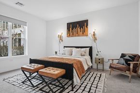 Framingham apartment for rent - A bedroom with a large bed and a painting above it.