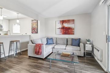 San Jose apartment for rent - A living room with a white couch and a red and white painting on the wall.
